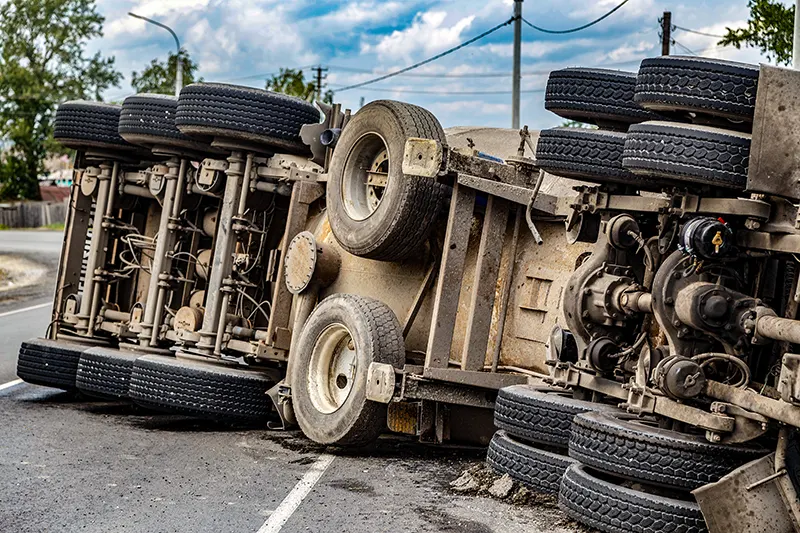 view of an overturned truck on an highway in an accident.