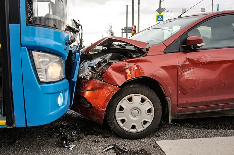 Frontal collision of a car and a bus. Head-on collision between bus and car. Car accident. Traffic accident.