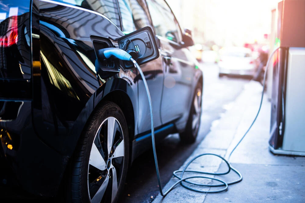 Charging modern electric car on the street which are the future of the Automobile