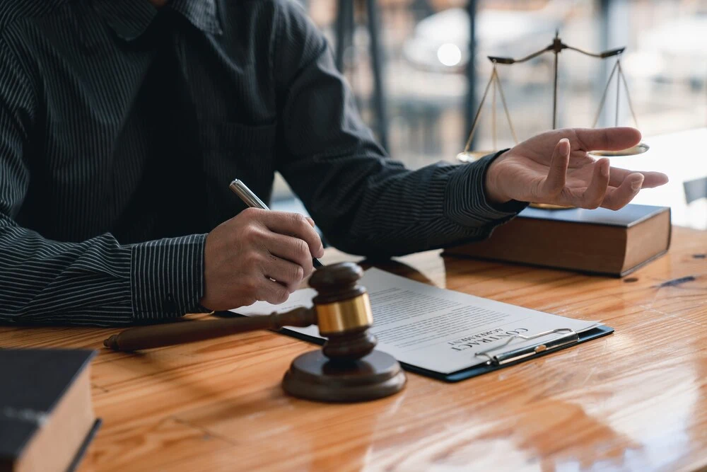 lawyer or judge is giving legal advice. to explaining about consultation terms and conditions to businessmen before signing on contract at a law firm.