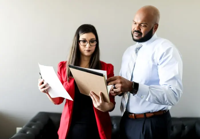 Woman and man inspecting a document