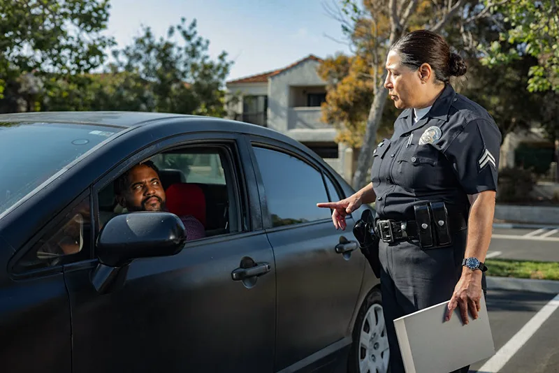 Policewoman Talking to a Man Riding in a Car, Police Report